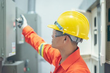 close up men working with the control cabinet