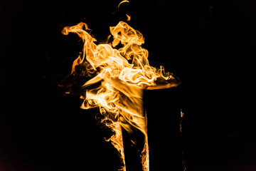 Detail close up shot of yellow and orange fire. Wooden log burning. Hot shiny burning fire on black...