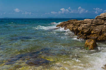Fototapeta na wymiar Waves breaking on a stony beach in Murter, Croatia, Dalmatia
