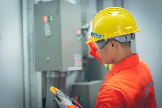 close up men working with the control cabinet
