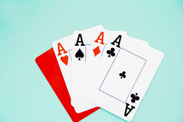 combination of four aces and red cutting card on blue isolated background
