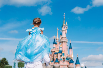 Little adorable girl in beautiful princess dress at fairy-tale park