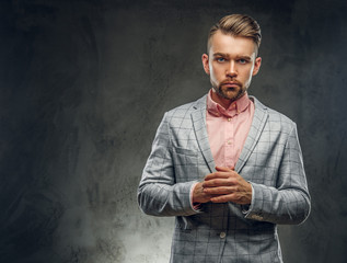 Studio shoot of styilish sceptical man in checkered blaze and pink shirt. 