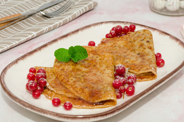 Crepes with berries and jam. 