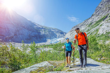 Happy couple hiking in mountains, active travel