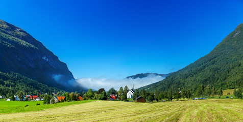 Amazing nature view with traditional Norwegian town and mountains. Location: Scandinavian Mountains, Norway. Beauty world. The feeling of complete freedom