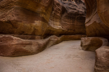 sand stone canyon road track narrow path way between steep rocky walls in Israel heritage touristic place