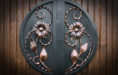 Decoration with forged elements of metal gates, flowers and leaves..