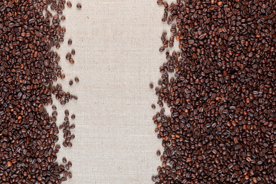 Roasted coffee beans on linea canvas with space on the left.