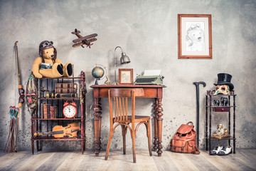 Vintage old typewriter, lamp, frame, forefinger on antique table, chair, Teddy Bear with photo camera, retro clock, books, fiddle, keys on shelf, plane, mask, cylinder hat, shoes, cane, backpack, bow