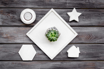 plant, concrete figures and tray decorations for morden home office on wooden background flat lay
