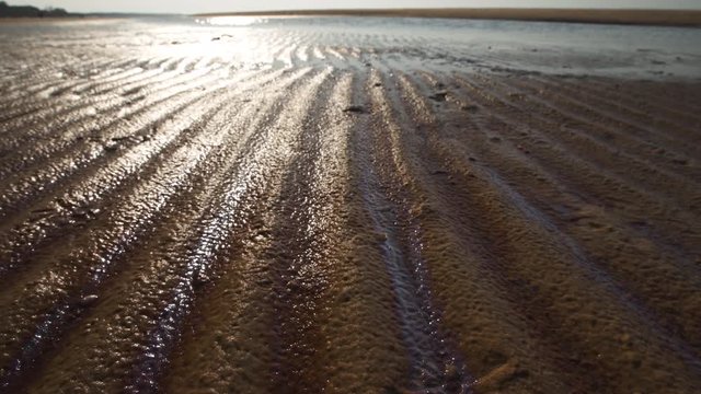 Ribbed sand - Baltic sea gulf beach with white sand in the sunset - 4K video with slow camera movement and inner stabilisation handheld