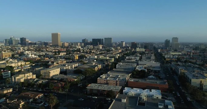 Aerial video of Downtown Los Angeles, California. ORBIT PAN long shot reveal DTLA. Clear day in the westside video by Airflow Creations. Palm Trees, Buildings, Homes, and traffic.