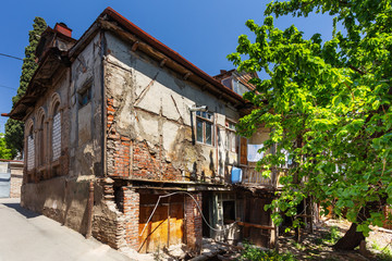 Fototapeta premium Tbilisi, old part of town with cobbled pavement and antique buildings. Old fashioned houses in historical quarter. Georgia.