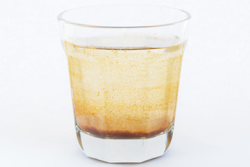 Contaminated water in a glass