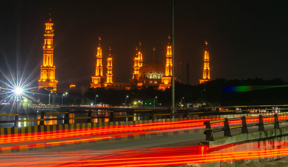 Fototapeta na wymiar Samarinda Islamic center at nigh, with light trails of traffic