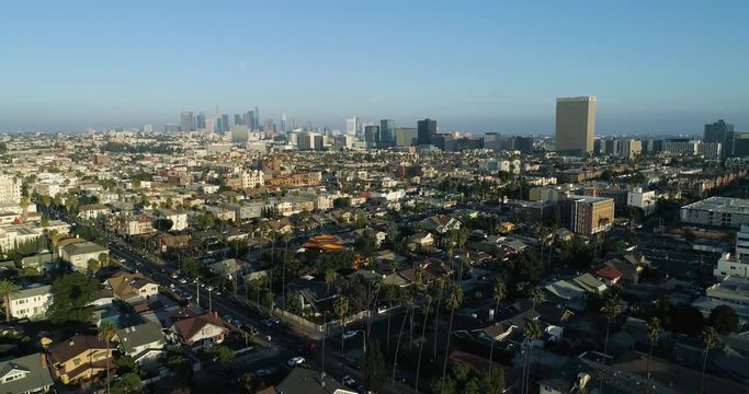 DTLA Aerial Slow Motion High Angle. Drone view of one of the most prestigious cities in US. Stock footage by Airflow Creations. Palm trees, Buildings, and traffic in rush hour at golden light. Slow Mo