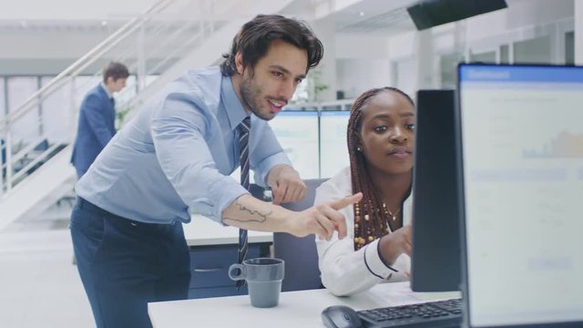 In the Busy Corporate Office: Manager Talks to Businesswoman who Works on Desktop Computer