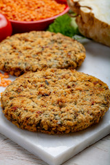 Tasty vegetarian food, raw burgers made from lentils legumes with vegetables ready for cooking