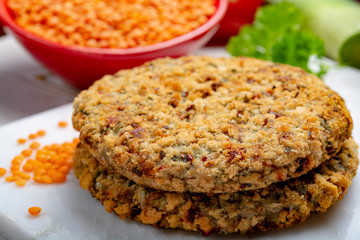 Tasty vegetarian food, raw burgers made from lentils legumes with vegetables ready for cooking