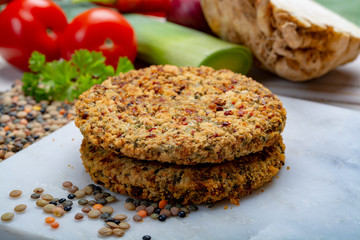 Tasty vegetarian food, raw burgers made from lentils legumes with vegetables ready for cooking