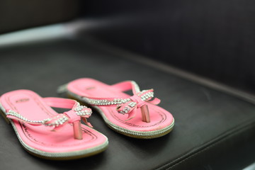  pink leather sandal on dark background, pair of sandals, pink sandal