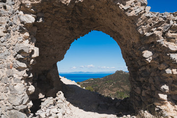 View on Tuscan coast through archway