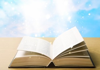Open Holy bible book on light background