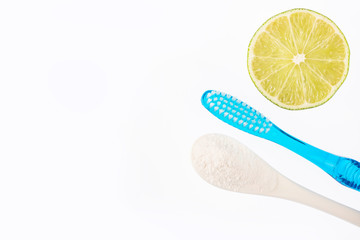 Toothbrush, bicarbonate and lemon - Citrus latifolia. Text space