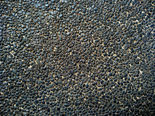 Gravel floor texture background. Floor background with stones. Rocks on the path for health. Round stone floor background.