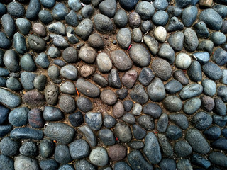 Gravel floor texture background. Floor background with stones. Rocks on the path for health. Round stone floor background.