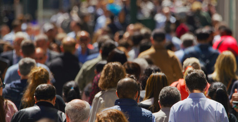 Crowd of people walking busy street in New York City