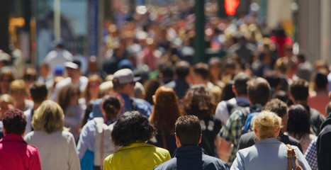 Crowd of people walking busy street in New York City