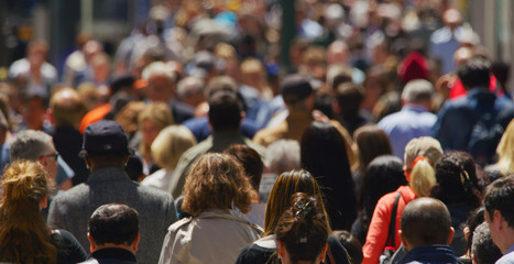 Crowd of people walking busy street in New York City