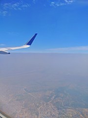 Fototapeta premium View from a plane window overlook a city.