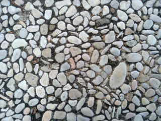 Gravel floor texture background. Floor background with stones. Rocks on the path for health. Round stone floor background.