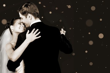 Bride and groom dancing on background