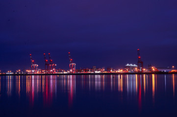 Fototapeta na wymiar Long Exposure image of Liverpool docks with beautiful reflections of colour over the River Mersey. Image was taken just after sunset. Liverpool UK