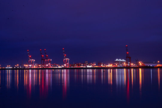 Long Exposure image of Liverpool docks with beautiful reflections of colour over the River Mersey. Image was taken just after sunset. Liverpool UK