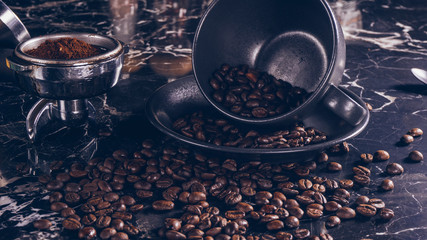 Coffee cup and beans on marble table