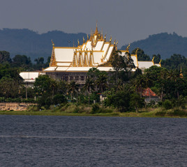 A Thai temple next to a lake 