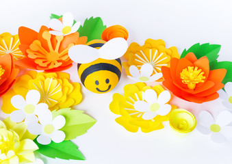 Holiday honey. white background. Handicraft bee painted egg. Easter. Origami paper flower. Diy