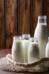Fresh milk in different glass bottles