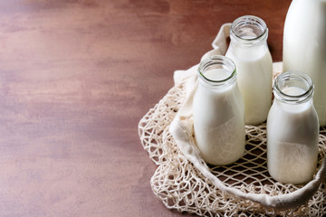 Fresh milk in different glass bottles