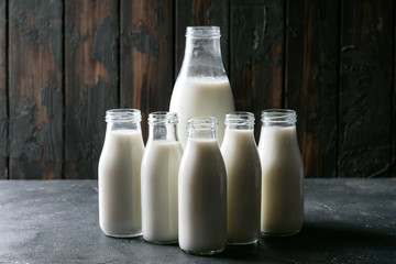Fresh milk in different glass bottles