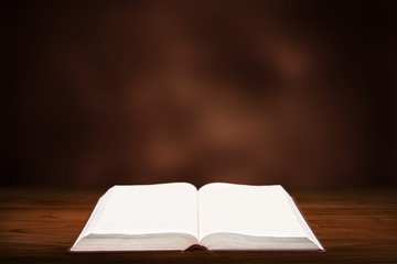 Open book on old wooden table.