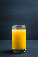Fresh squeezed orange juice on the rustic background. Selective focus. Shallow depth of field. 