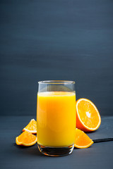 Fresh squeezed orange juice on the rustic background. Selective focus. Shallow depth of field. 