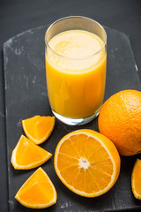 Fresh squeezed orange juice on the rustic background. Selective focus. Shallow depth of field. 