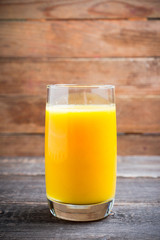 Fresh squeezed orange juice on the rustic background. Selective focus. Shallow depth of field. 
